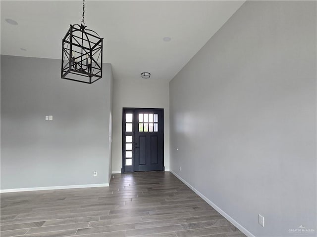 entryway with high vaulted ceiling and light hardwood / wood-style floors