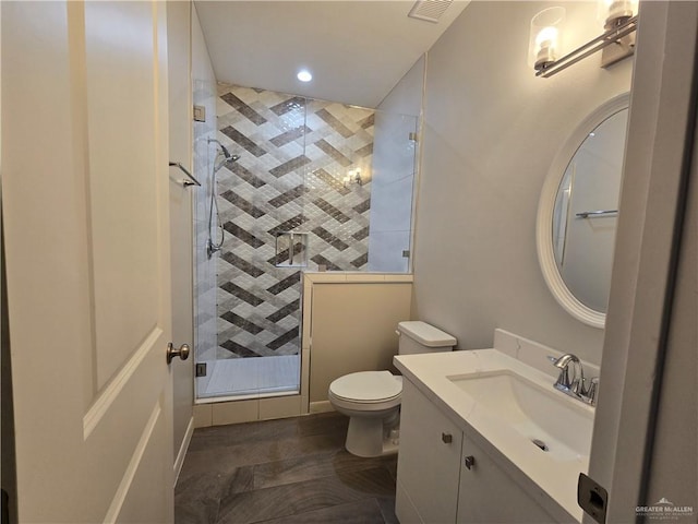 bathroom with toilet, vanity, and walk in shower