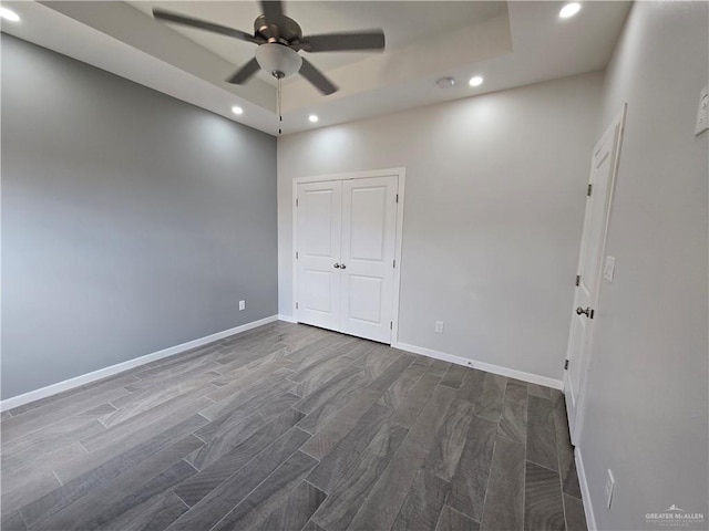 empty room featuring ceiling fan and dark hardwood / wood-style floors