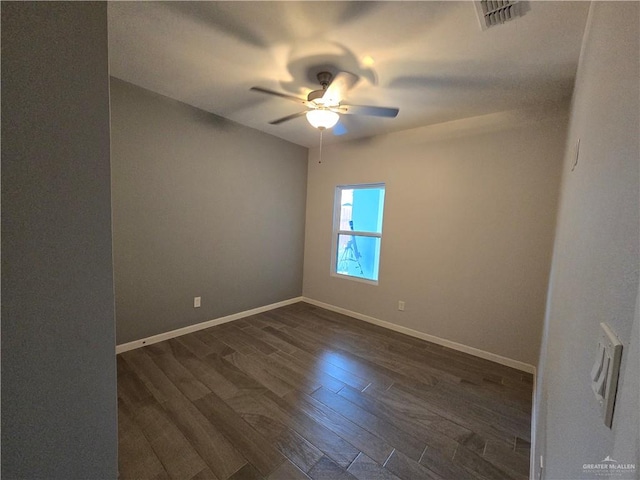 spare room with dark hardwood / wood-style floors and ceiling fan