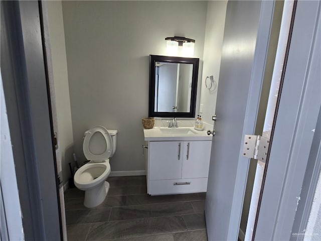 bathroom featuring tile patterned floors, vanity, and toilet