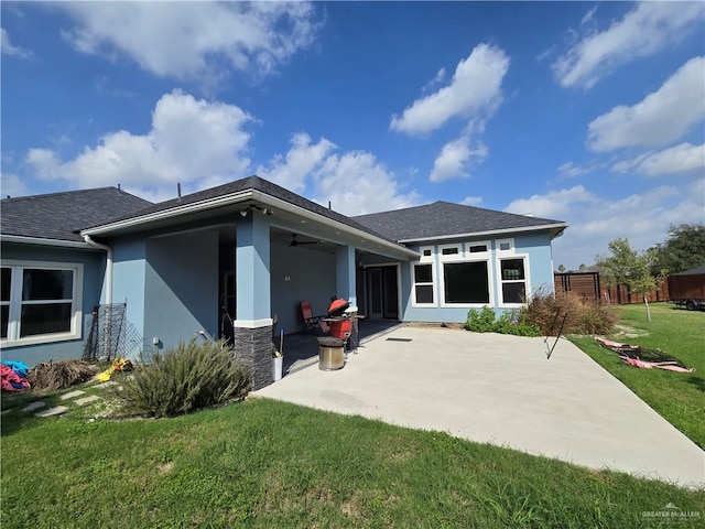 back of house with a lawn, a patio area, and ceiling fan