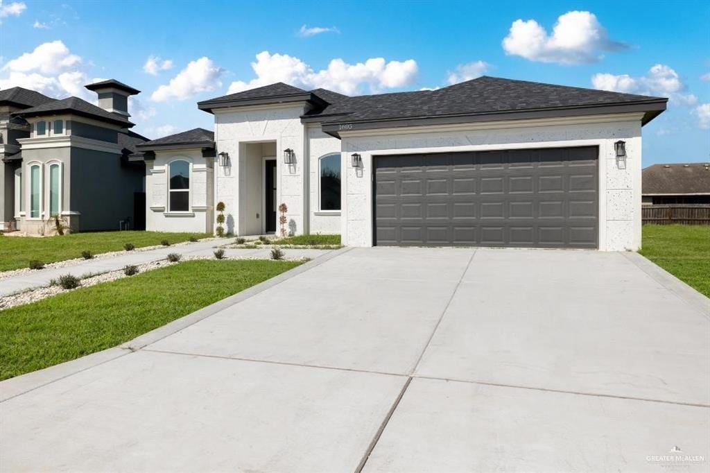 view of front of property with a front lawn and a garage