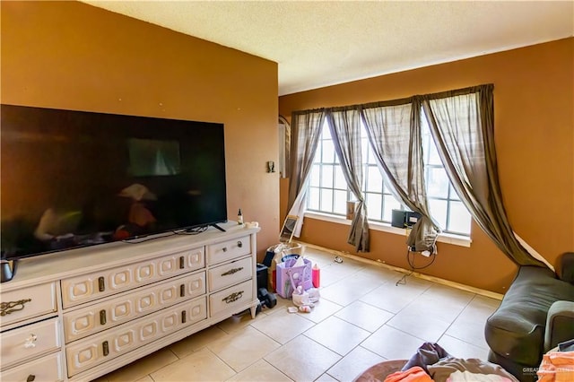 living room with light tile patterned floors and a textured ceiling