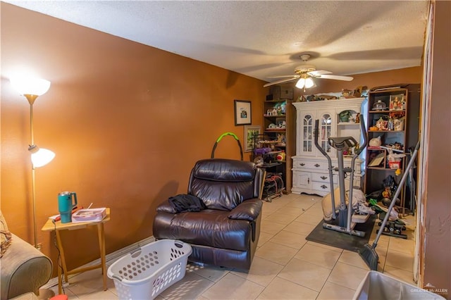 interior space with ceiling fan and a textured ceiling