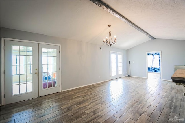 interior space featuring vaulted ceiling with beams, an inviting chandelier, dark hardwood / wood-style flooring, and french doors