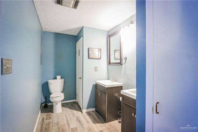 bathroom featuring hardwood / wood-style floors, vanity, and toilet