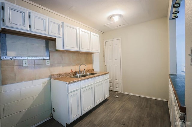 kitchen with white cabinets, decorative backsplash, dark hardwood / wood-style flooring, and sink