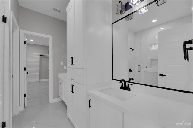 bathroom with vanity and a shower with shower door