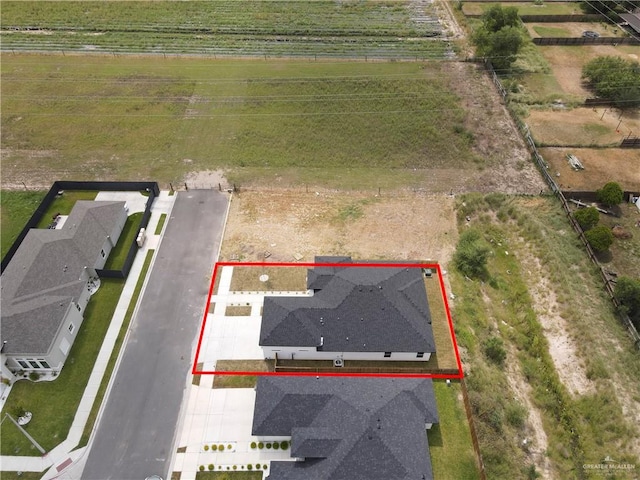 birds eye view of property with a rural view