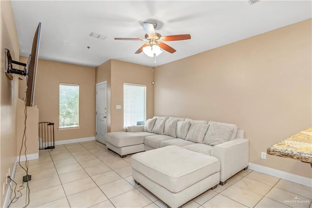 tiled living room featuring ceiling fan