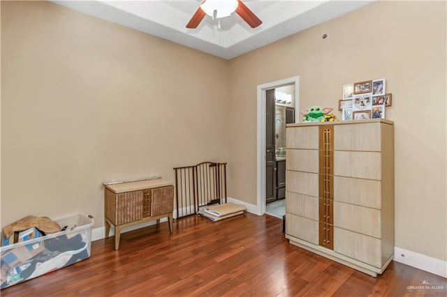 interior space featuring ceiling fan and dark hardwood / wood-style flooring