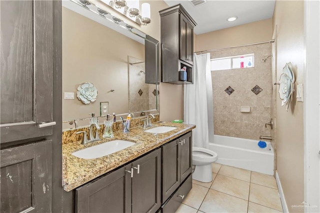 full bathroom featuring toilet, tile patterned flooring, vanity, and shower / tub combo with curtain