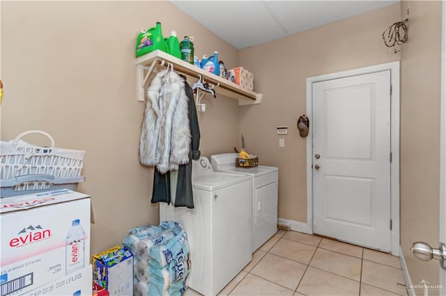 clothes washing area featuring independent washer and dryer and light tile patterned floors