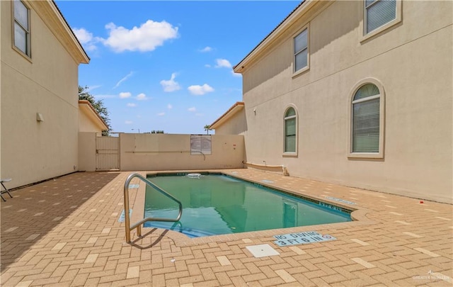 view of swimming pool with a patio