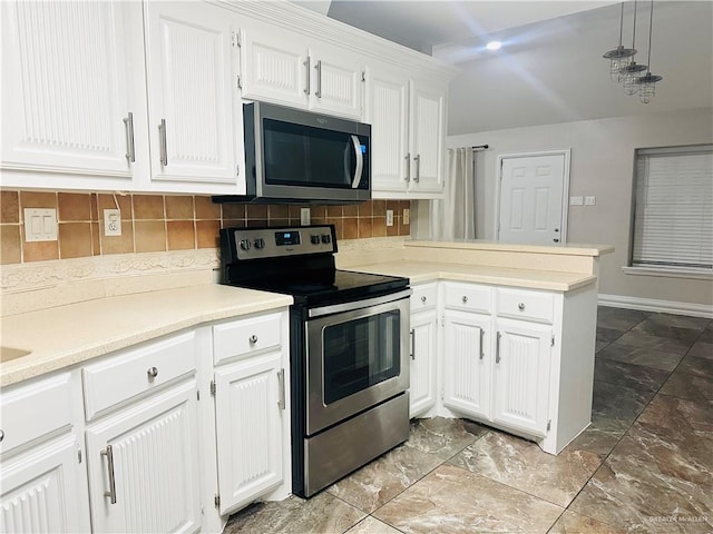 kitchen with appliances with stainless steel finishes, decorative light fixtures, white cabinetry, decorative backsplash, and kitchen peninsula