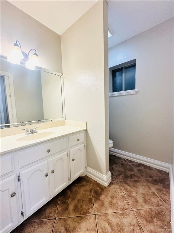 bathroom with vanity, tile patterned floors, and toilet