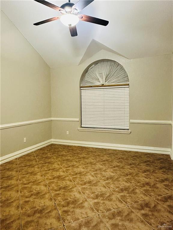 unfurnished room featuring lofted ceiling