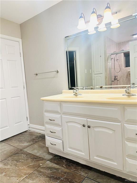 bathroom with vanity and walk in shower