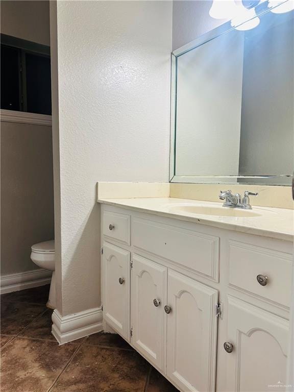 bathroom with vanity, tile patterned floors, and toilet