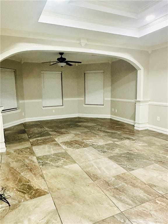 spare room featuring a tray ceiling, ornamental molding, and ceiling fan