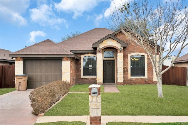 view of front of property with a garage and a front lawn