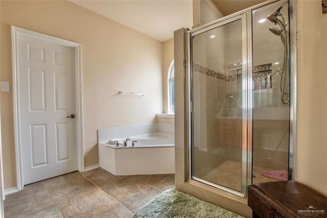 bathroom featuring tile patterned floors and shower with separate bathtub