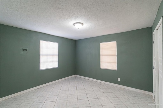 unfurnished room with a textured ceiling