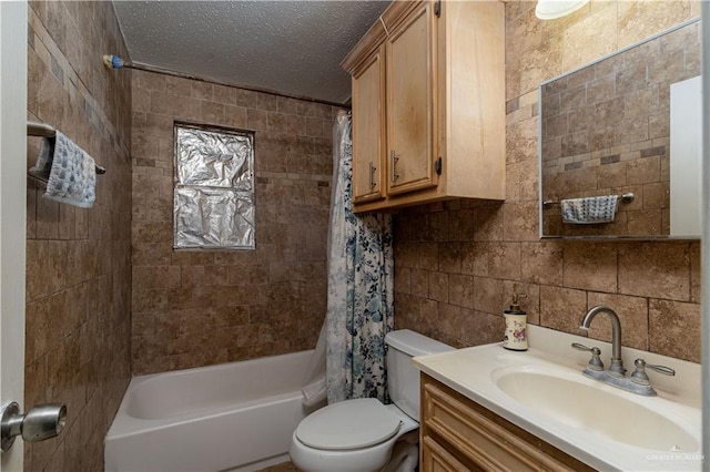 full bathroom with shower / bath combo, vanity, a textured ceiling, tile walls, and toilet