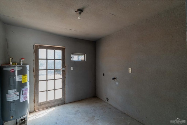 interior space featuring concrete flooring and water heater