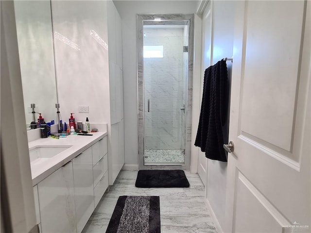 bathroom featuring a shower stall, marble finish floor, and vanity