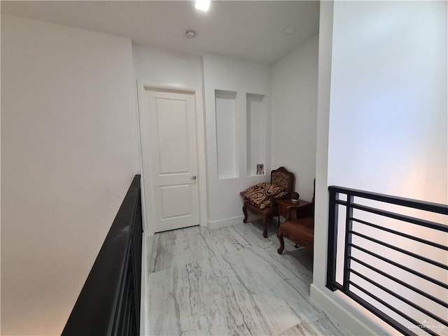 corridor with marble finish floor