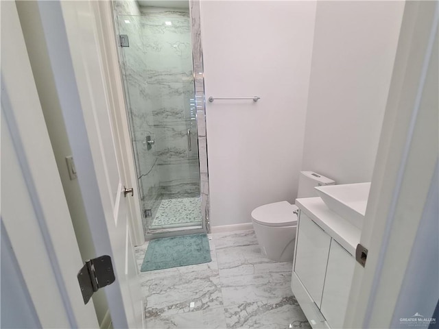 full bathroom featuring toilet, a marble finish shower, marble finish floor, and vanity