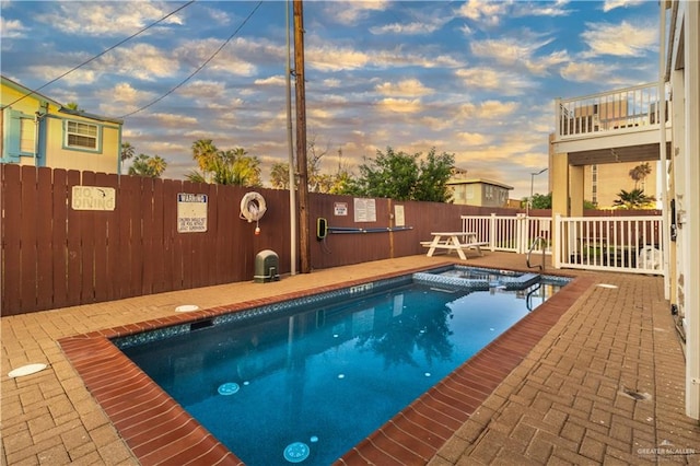 view of pool at dusk