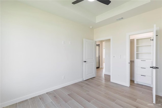 1027 Broken Arrow Dr, Alamo, TX 78516 - unfurnished bedroom with light wood-type flooring, a walk in closet, and baseboards