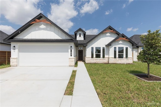 1027 Broken Arrow Dr, Alamo, TX 78516 - view of front of house with stone siding, board and batten siding, a front yard, an attached garage, and driveway