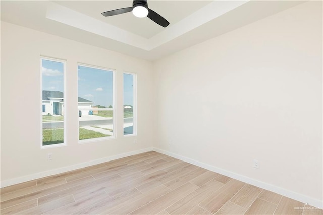 1027 Broken Arrow Dr, Alamo, TX 78516 - empty room with a raised ceiling, light wood-style flooring, baseboards, and ceiling fan