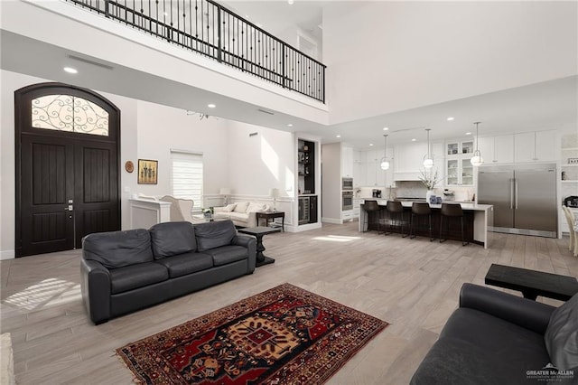 8101 N 5th St, Mcallen, TX 78504 - living area with a towering ceiling, light wood-style floors, baseboards, and recessed lighting