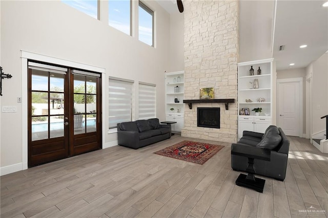 8101 N 5th St, Mcallen, TX 78504 - living area featuring baseboards, light wood finished floors, a fireplace, and a healthy amount of sunlight