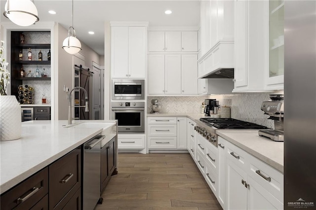 8101 N 5th St, Mcallen, TX 78504 - kitchen featuring stainless steel appliances, a barn door, and white cabinets
