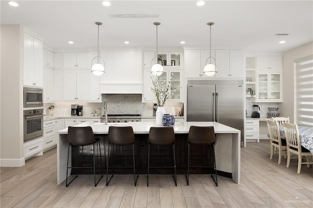 8101 N 5th St, Mcallen, TX 78504 - kitchen featuring light wood finished floors, light countertops, and built in appliances