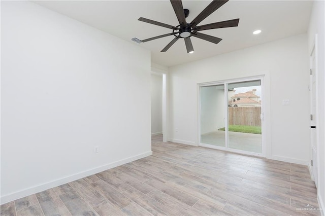 empty room featuring light hardwood / wood-style flooring and ceiling fan