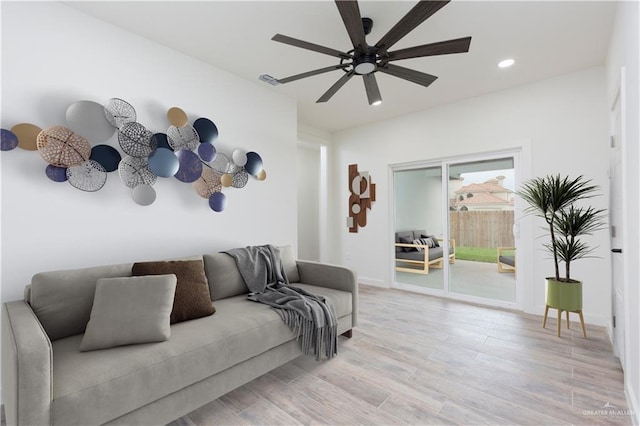 living room with ceiling fan and light hardwood / wood-style floors