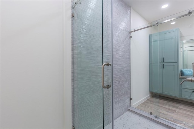 bathroom with a shower with door