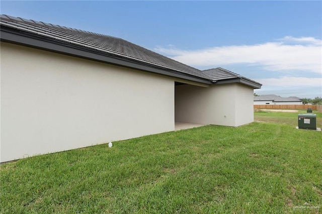 view of side of home featuring a yard