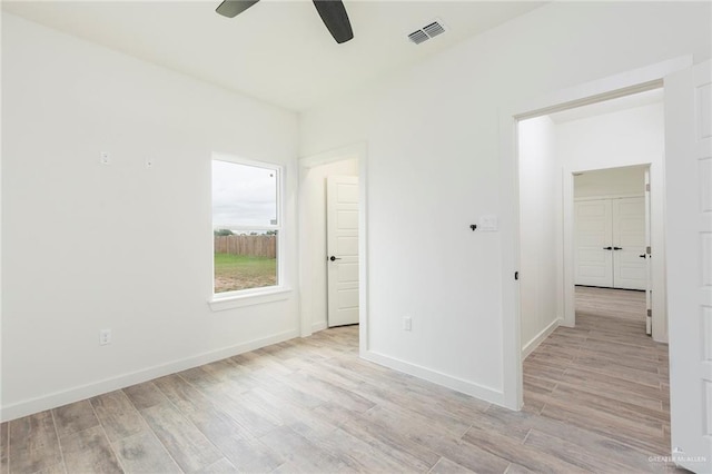 unfurnished room featuring light hardwood / wood-style floors and ceiling fan