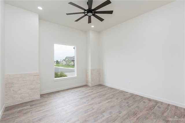 unfurnished room with ceiling fan and light hardwood / wood-style floors