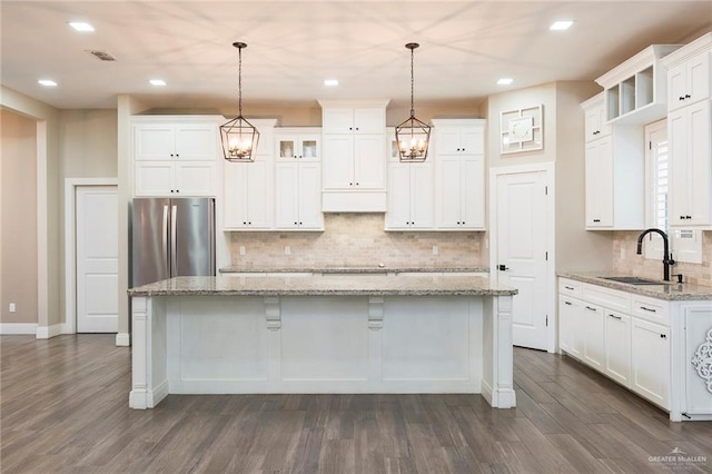 kitchen with a center island, hanging light fixtures, and sink