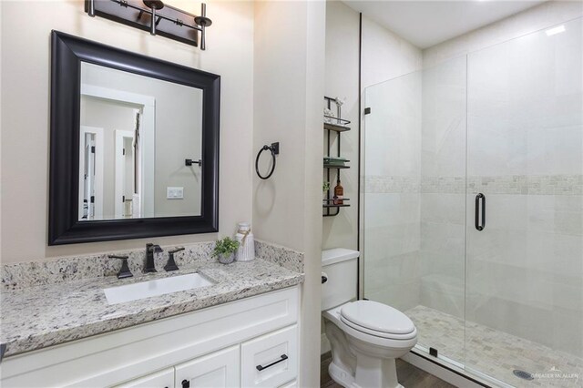 bathroom with vanity, toilet, and walk in shower