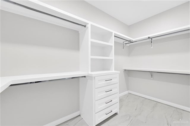 spacious closet with marble finish floor